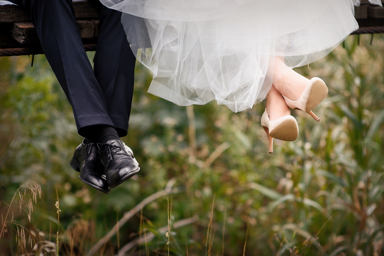 feet of bride and groom, wedding shoes.